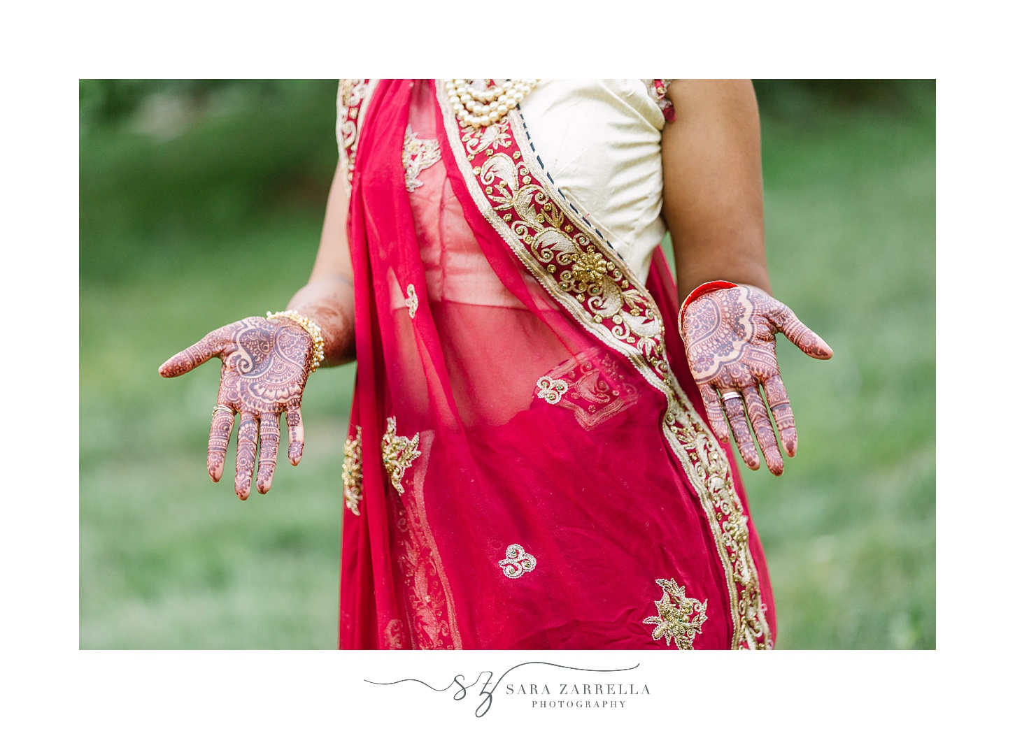 bride shows Henna tattoos on hand during wedding day