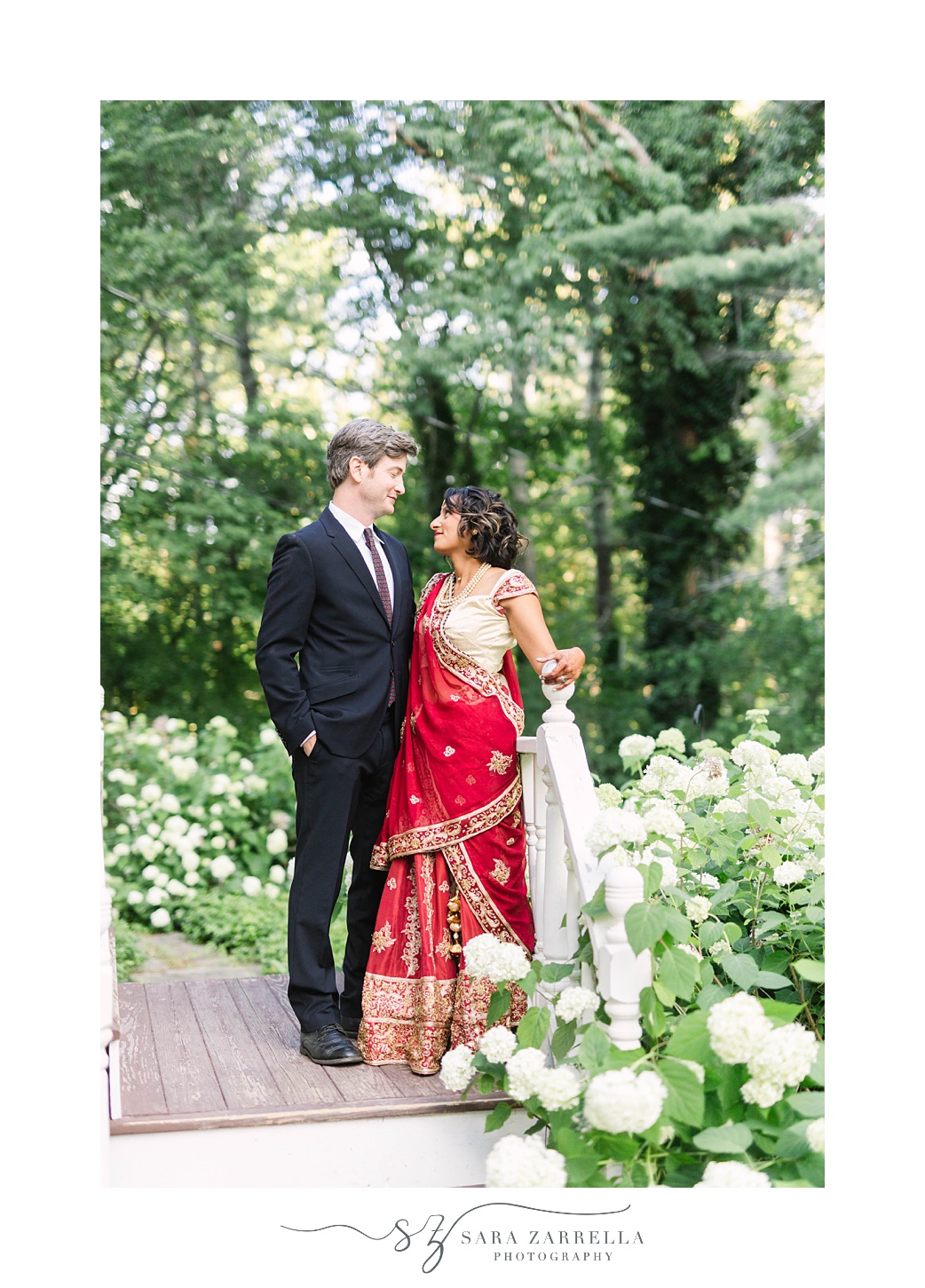 groom talks to bride in red and gold lengha