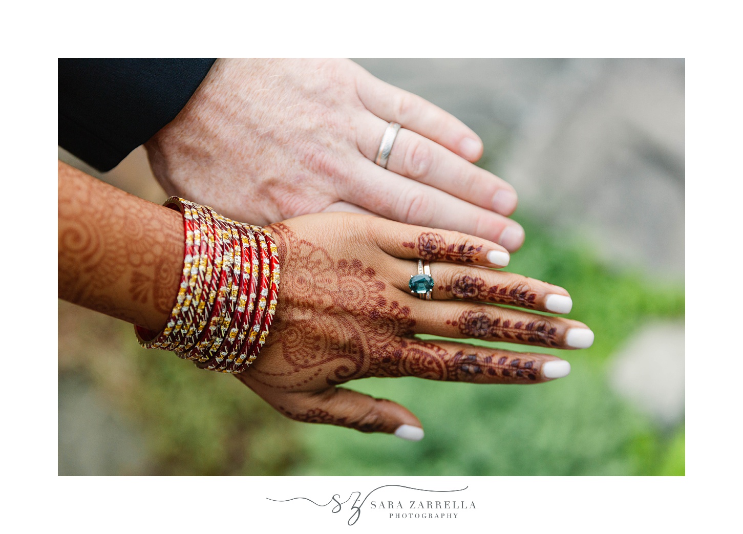 bride shows Henna on hand and wedding bands 