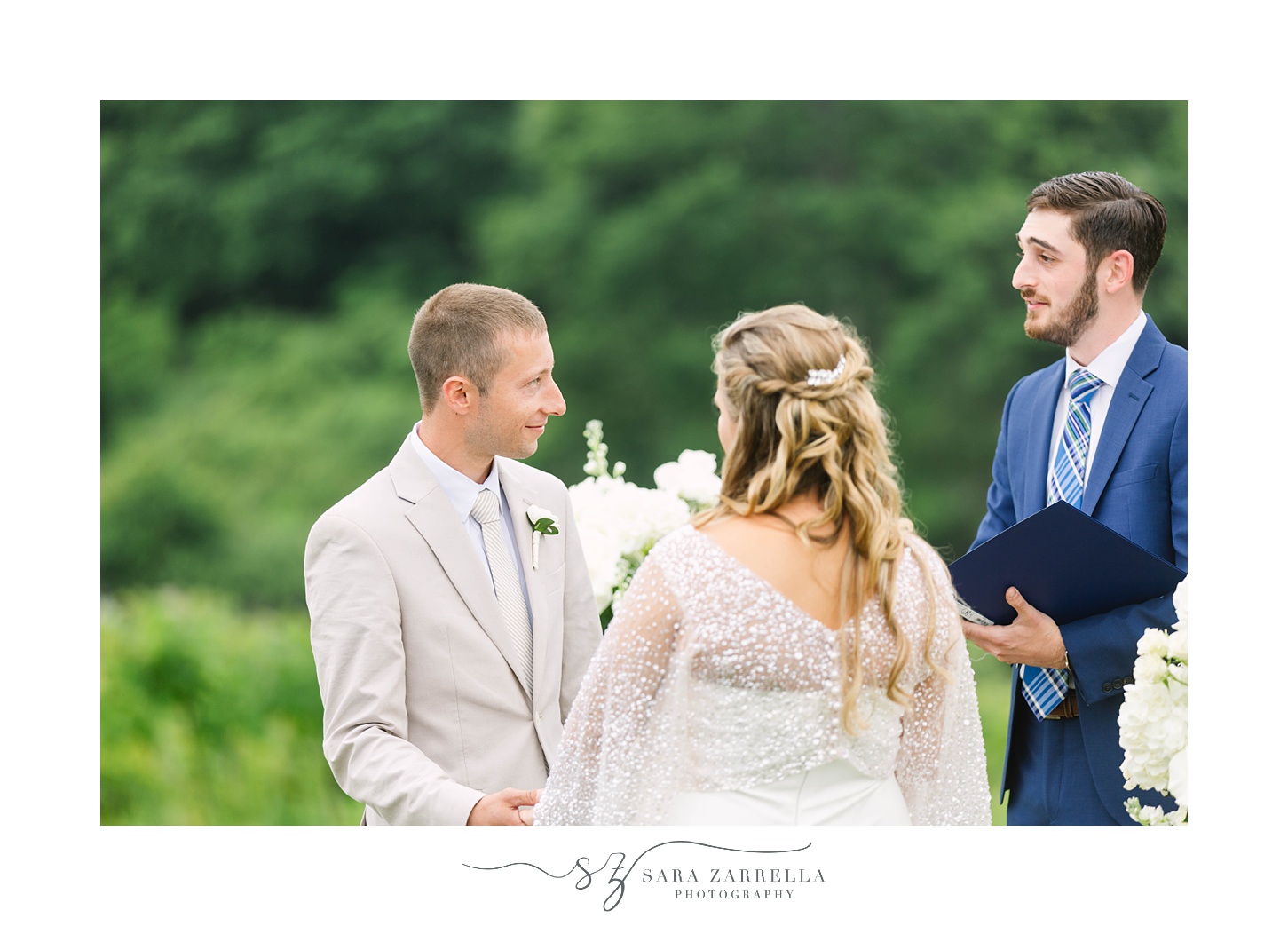 groom holds bride's hands during vows