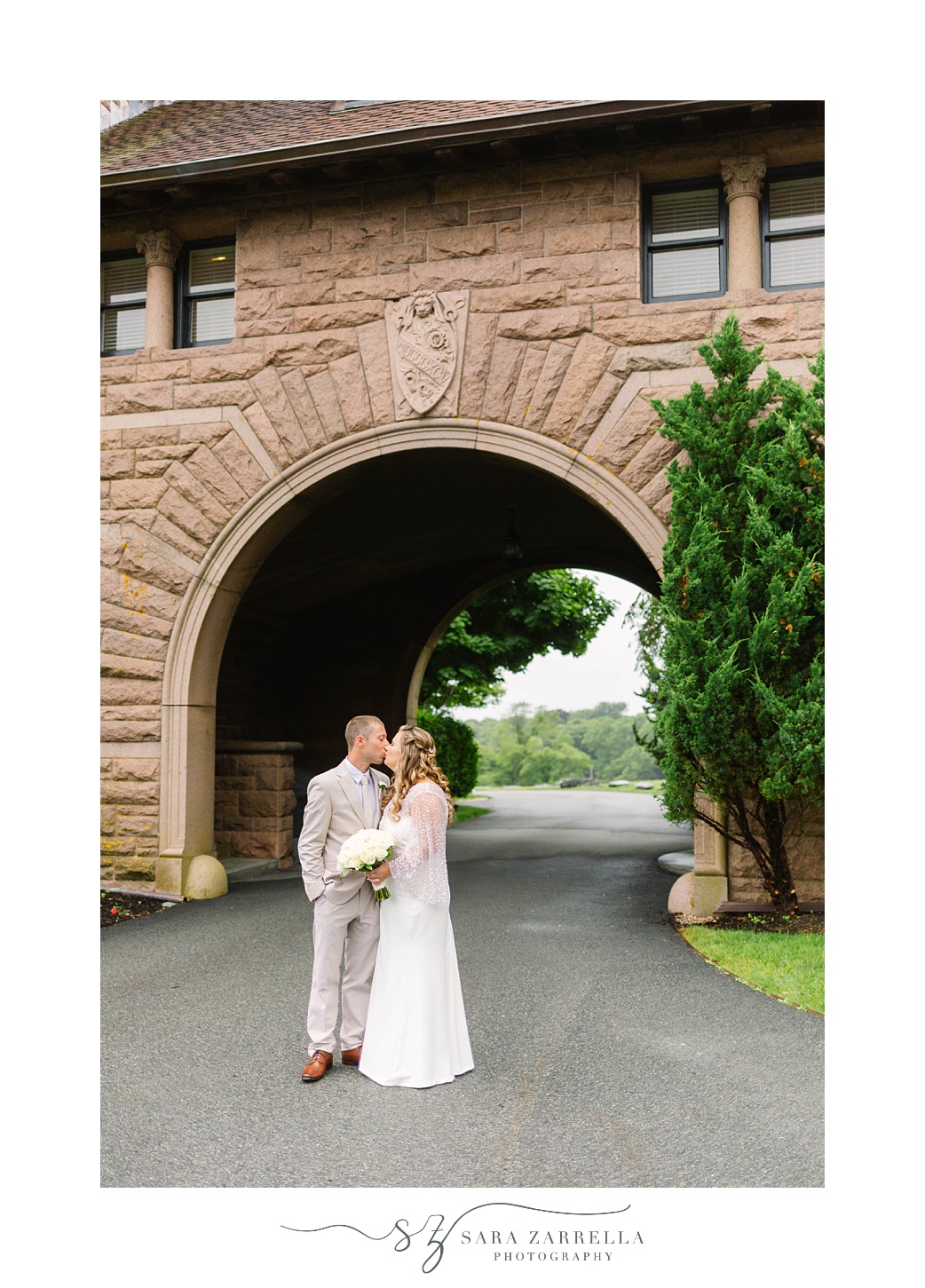bride and groom kiss under arch at OceanCliff Hotel