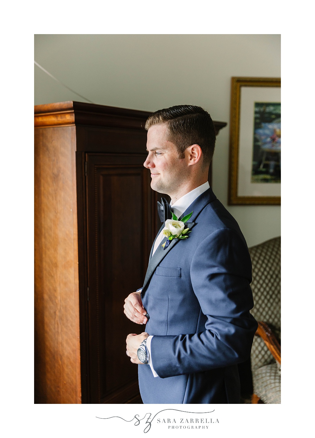 groom prepares in blue tux for OceanCliff Hotel Vow Renewal