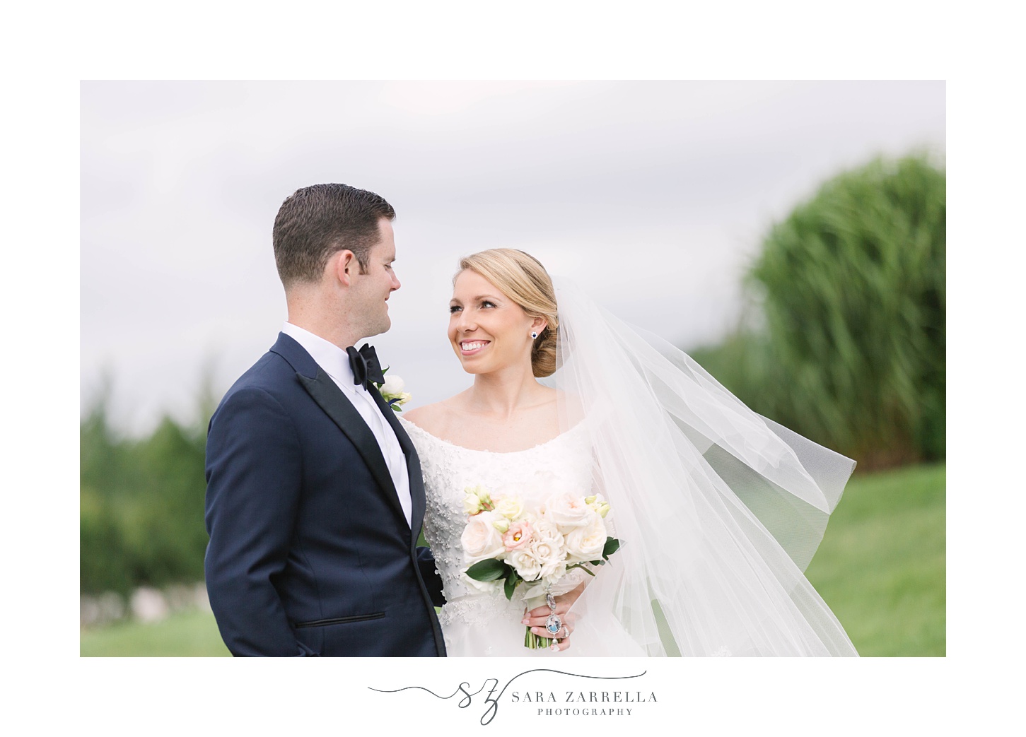 bride smiles at groom during portraits in Newport RI