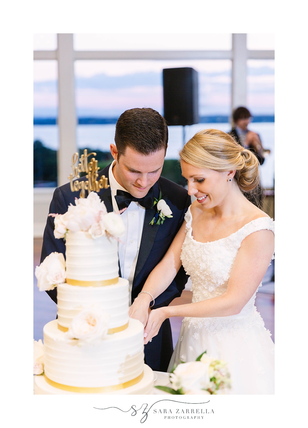 husband and wife cut cake during Newport RI wedding reception