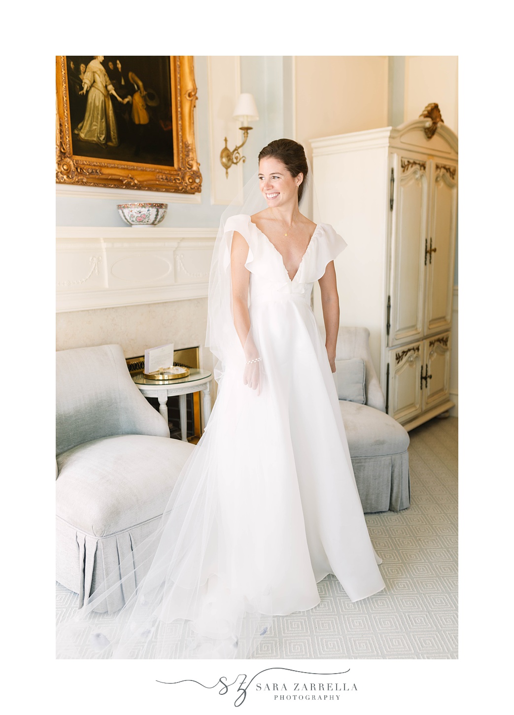 bride poses in sitting room at The Chanler at Cliff Walk