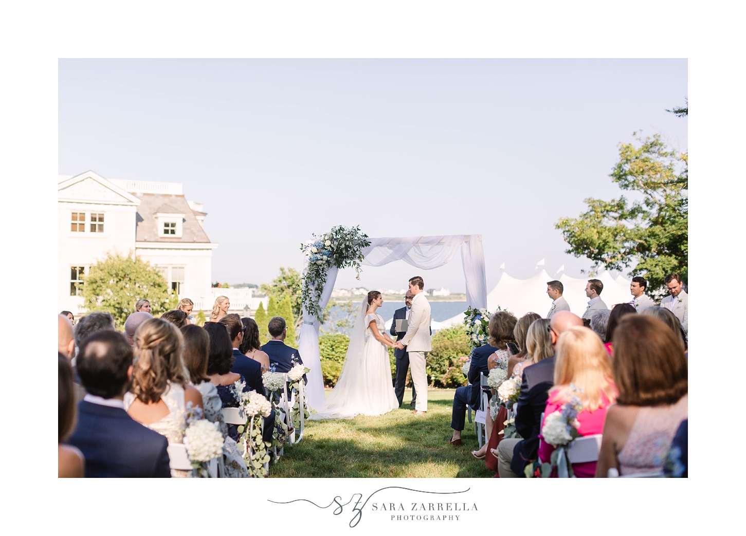 bride and groom exchange vows at The Chanler at Cliff Walk