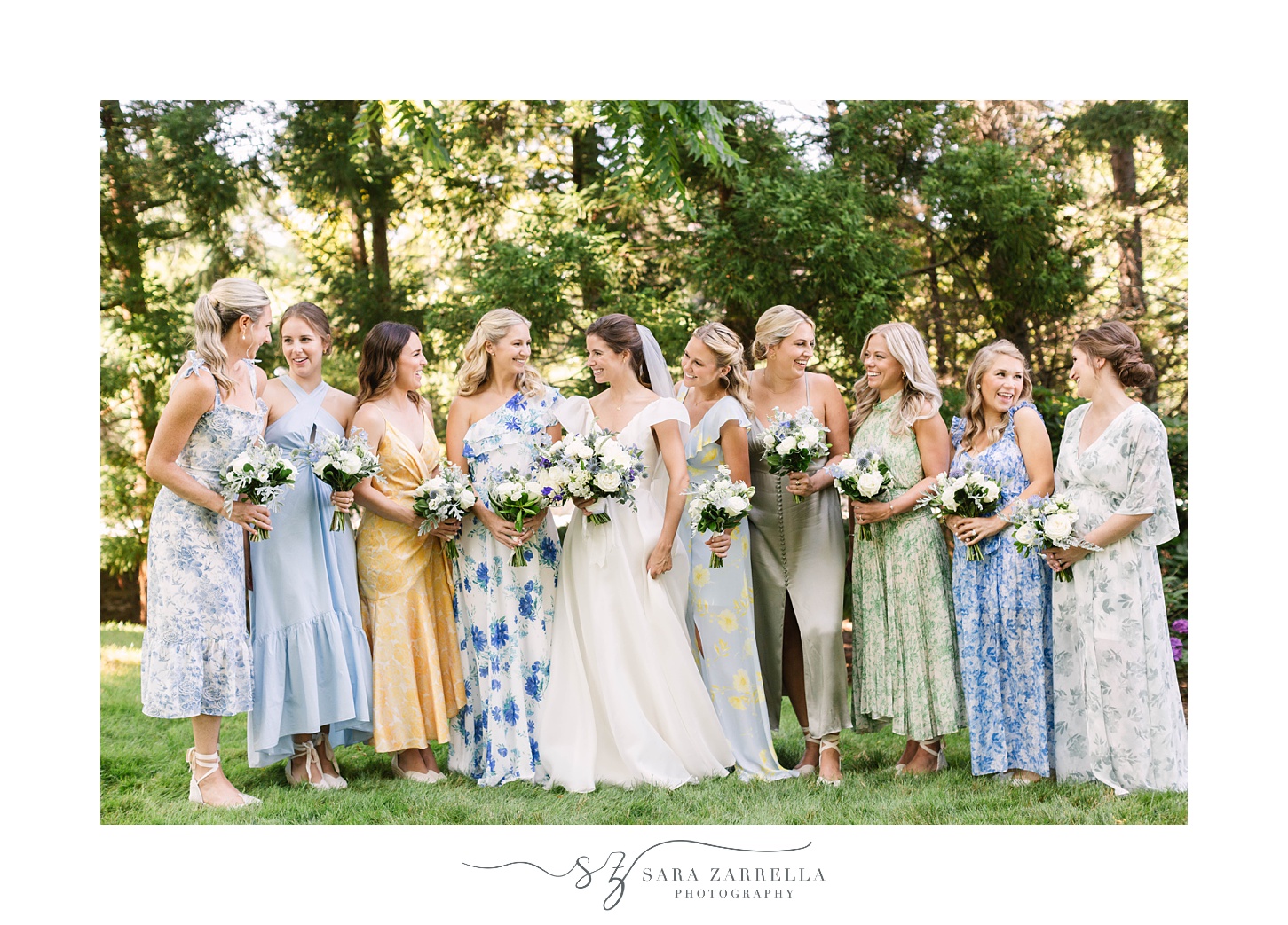 bride poses with bridesmaids in garden party inspired gowns