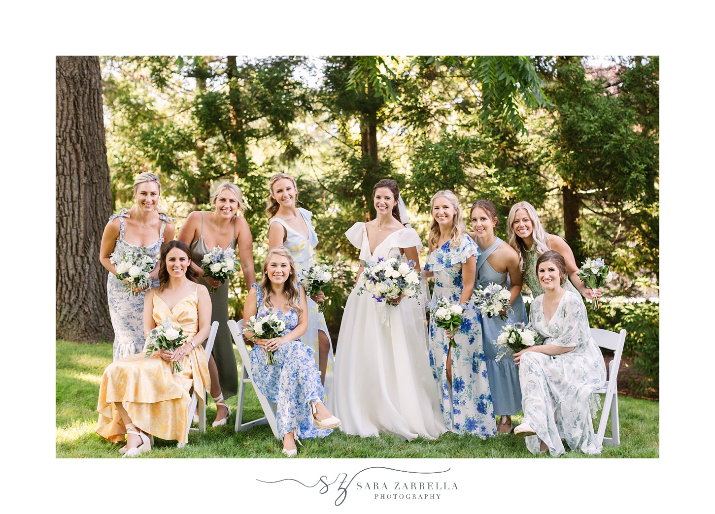 bride poses with bridesmaids in garden party inspired gowns