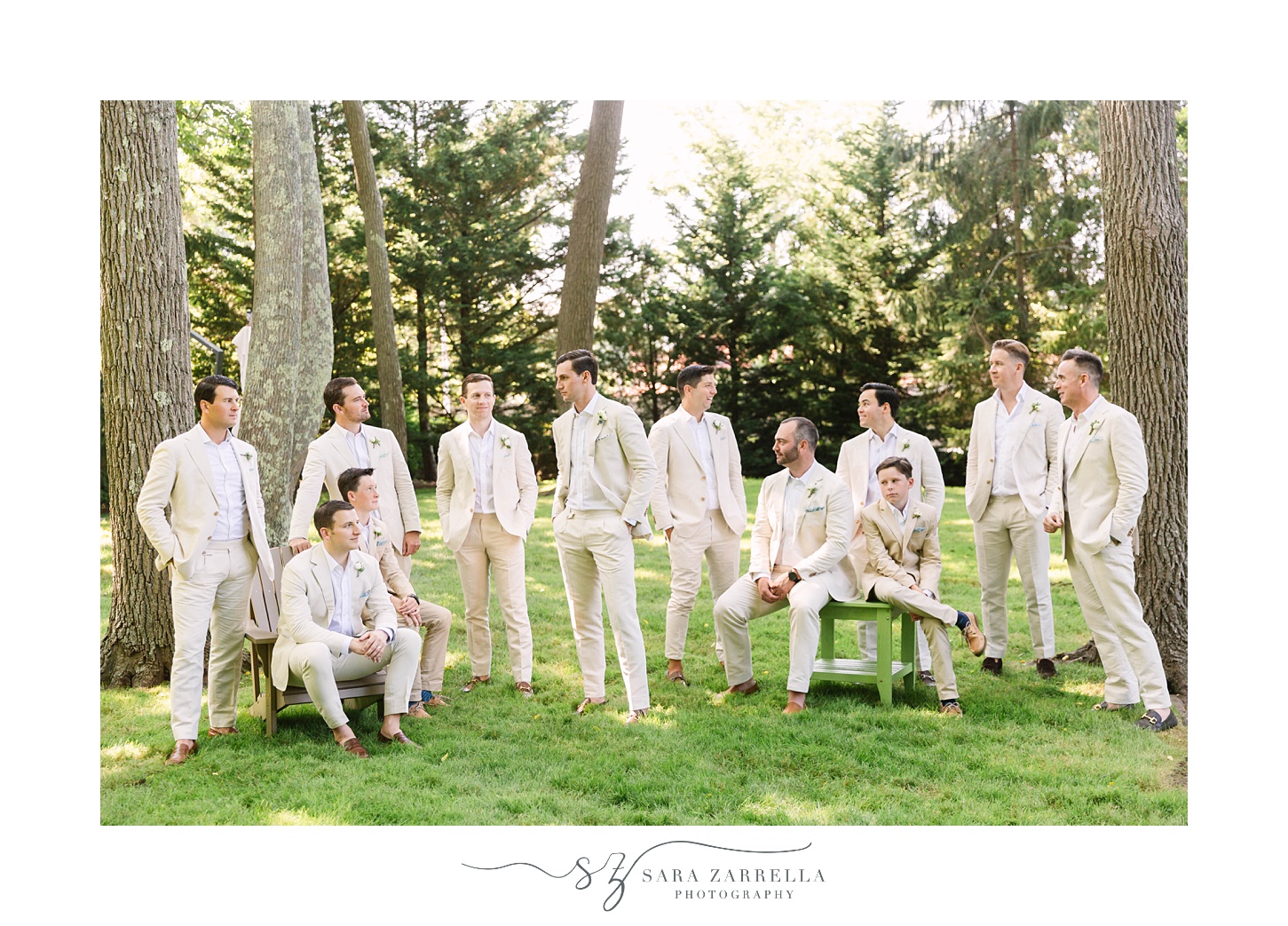 groom and groomsmen pose in garden at The Chanler at Cliff Walk