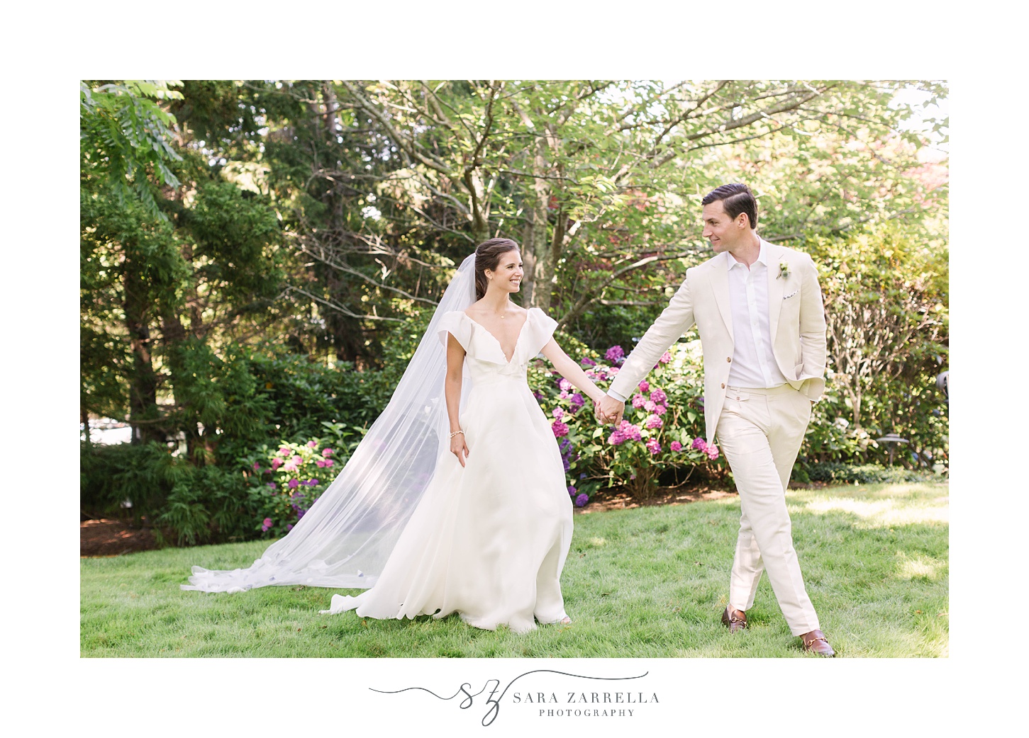 groom leads bride through garden at The Chanler at Cliff Walk