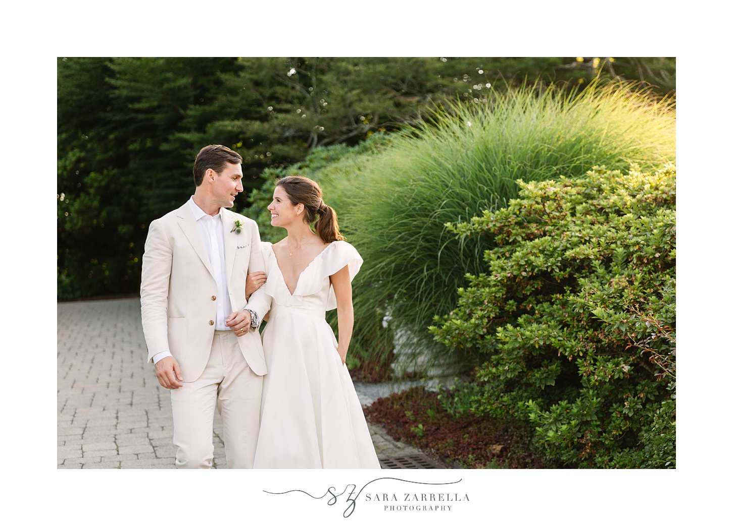 bride and groom walk through garden of The Chanler at Cliff Walk