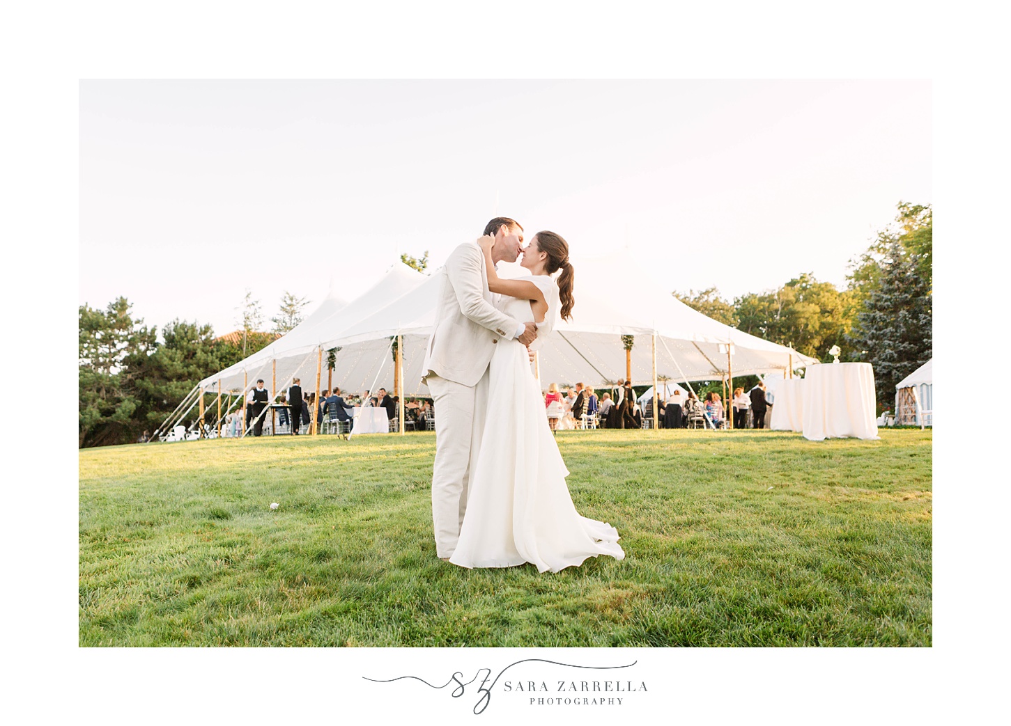 bride and groom kiss outside tent at The Chanler at Cliff Walk