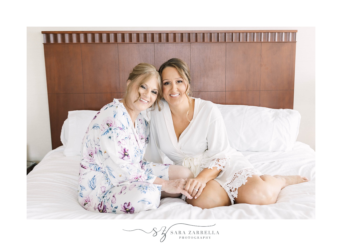 bride and mom sit on bed before RI wedding day