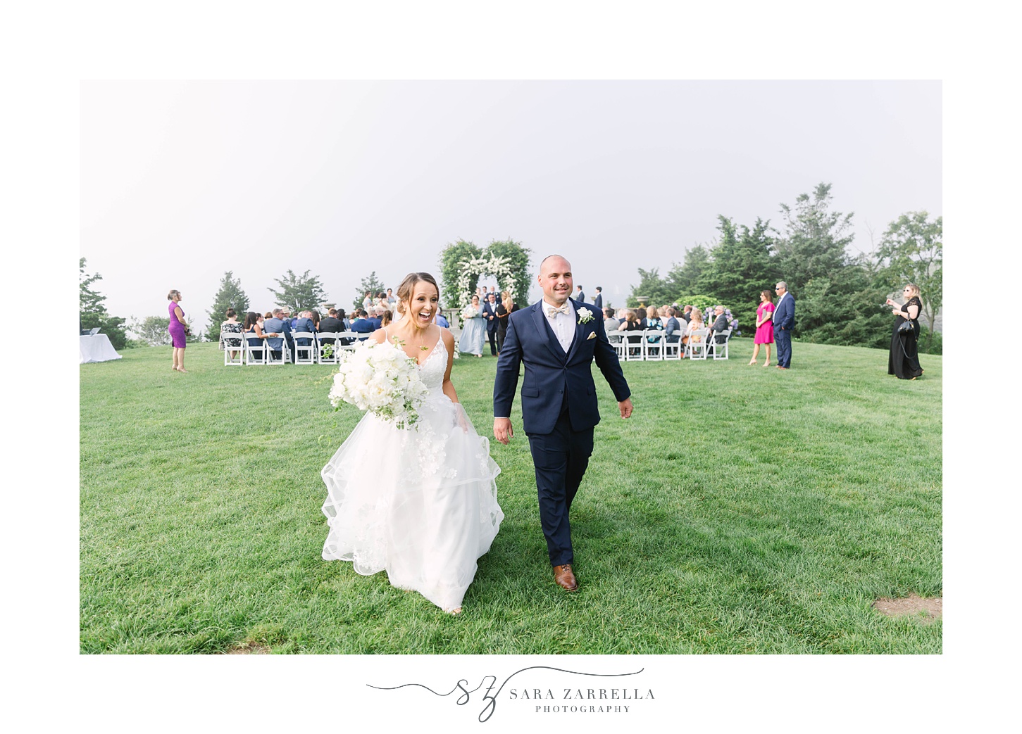 bride and groom walk up aisle after waterfront wedding ceremony in Rhode Island