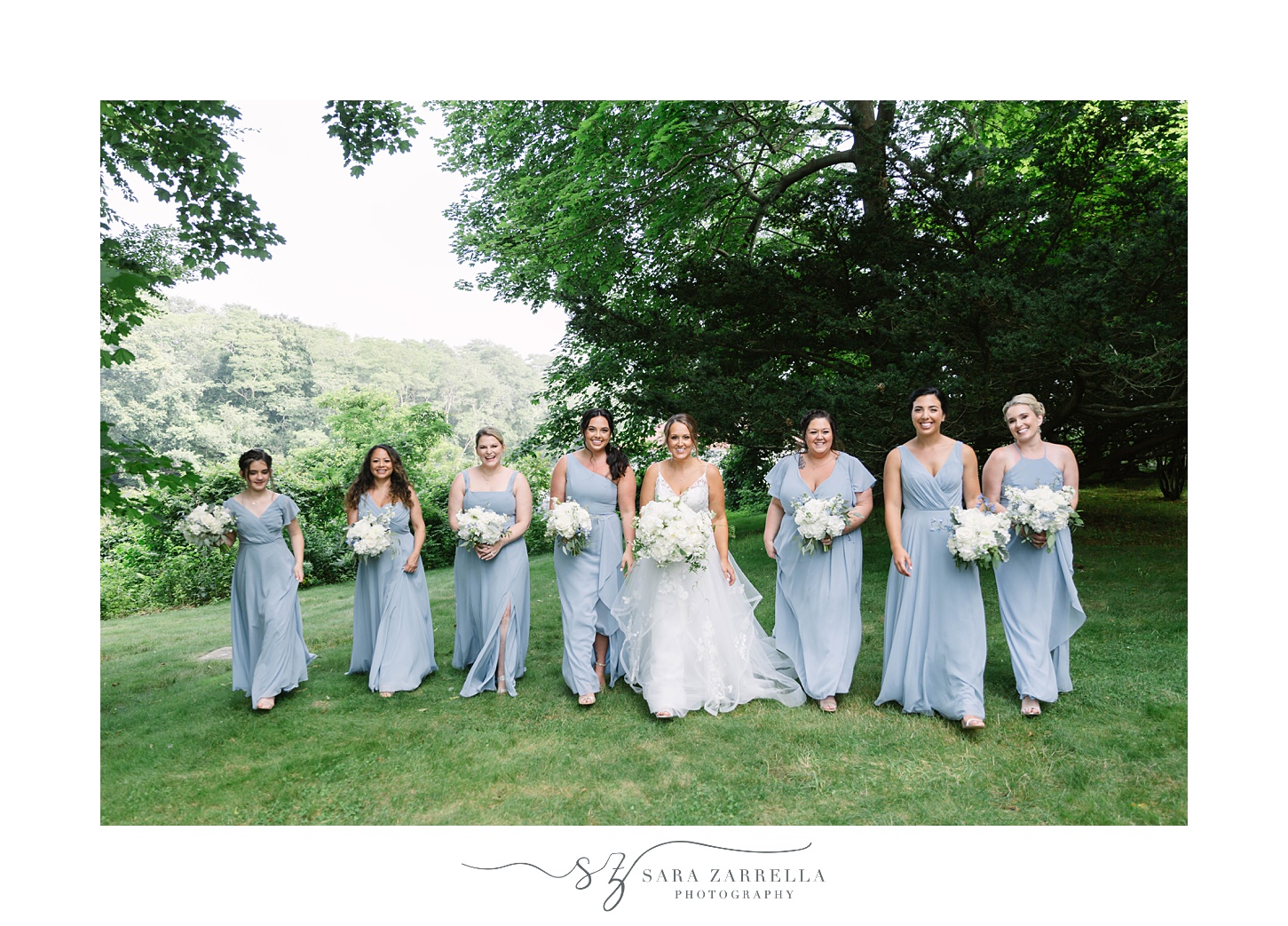 bride walks with bridesmaids in light blue gowns