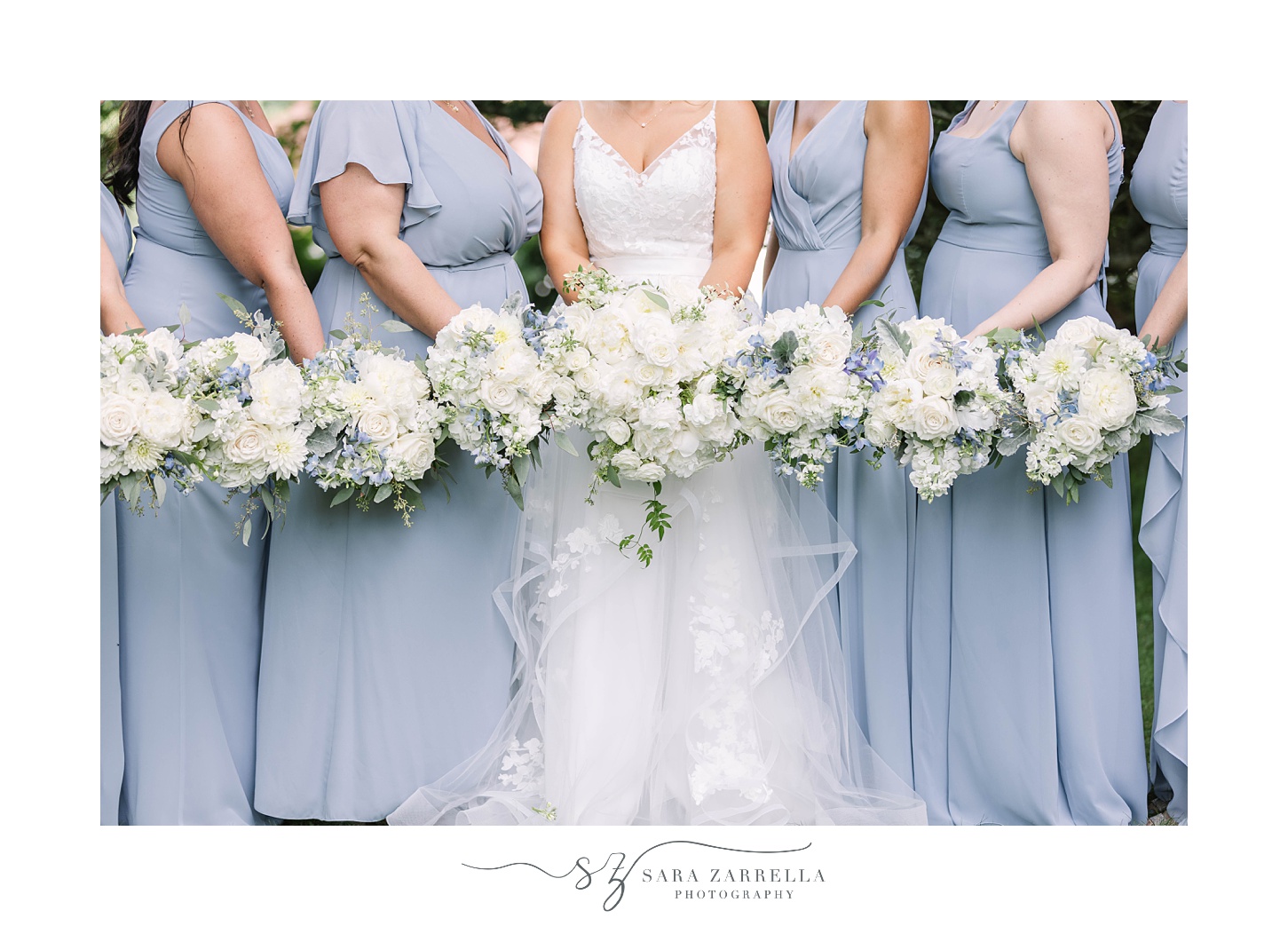 bride and bridesmaids hold ivory bouquets at Castle Hill Inn wedding