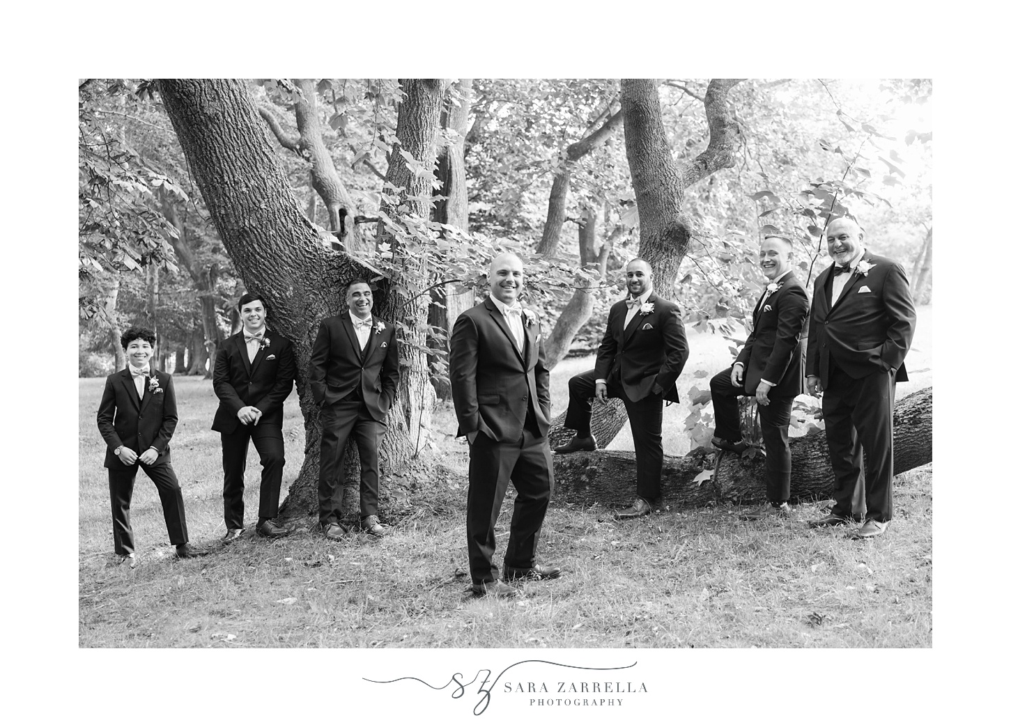 groom poses with groomsmen at Castle Hill Inn