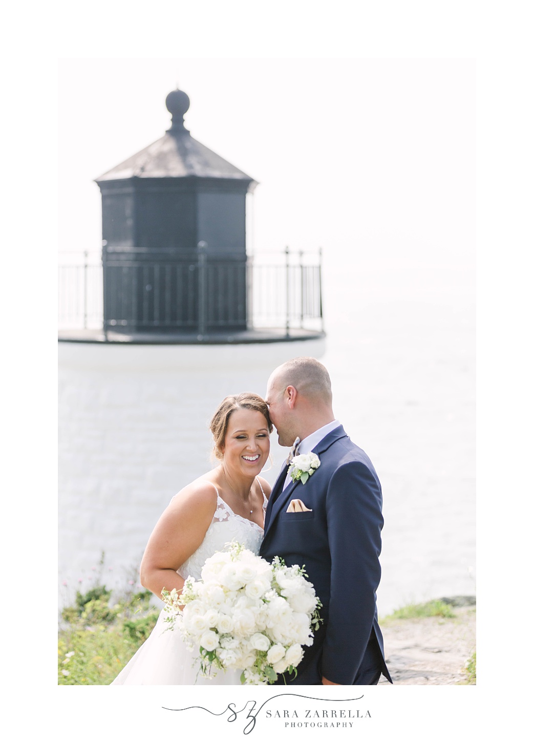 newlyweds pose by Newport RI lighthouse 