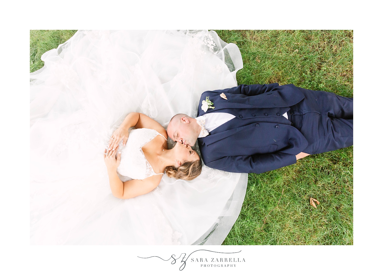bride and groom lay in grass