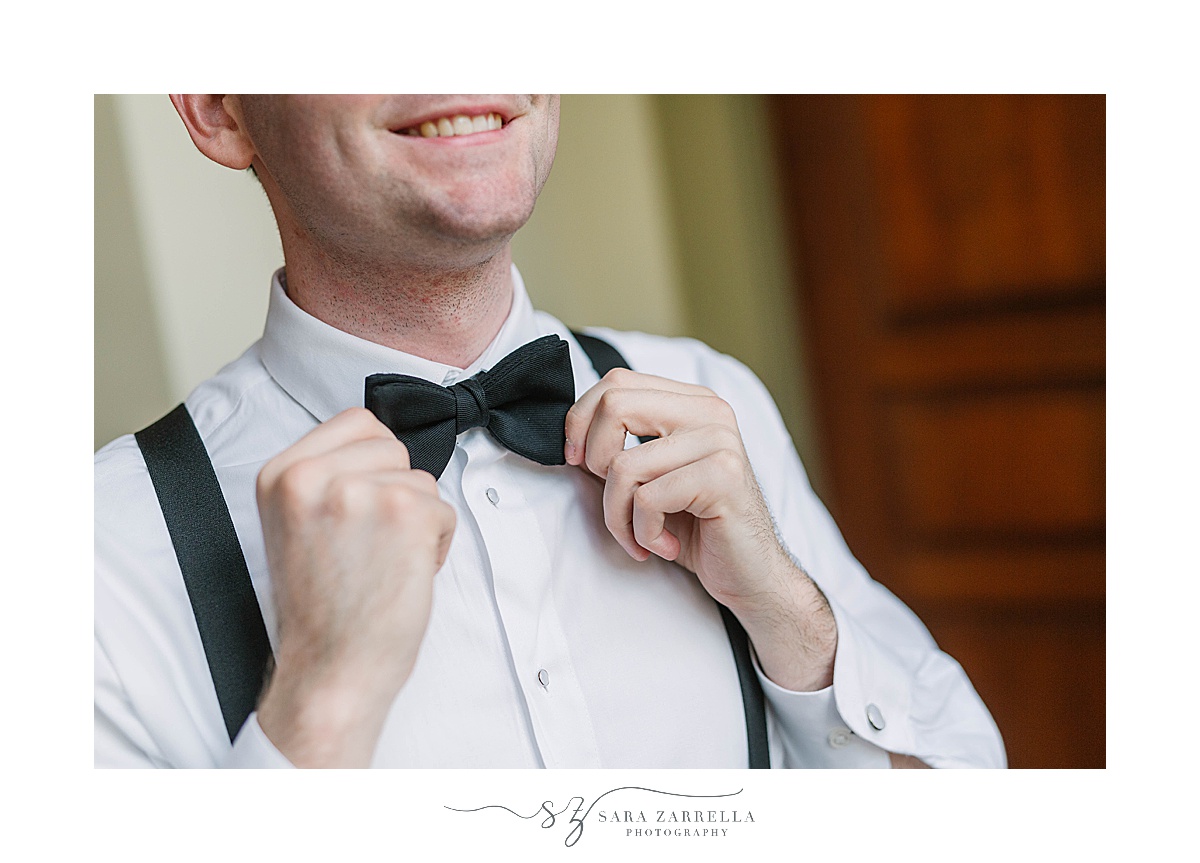 groom adjusts tie before Providence College wedding