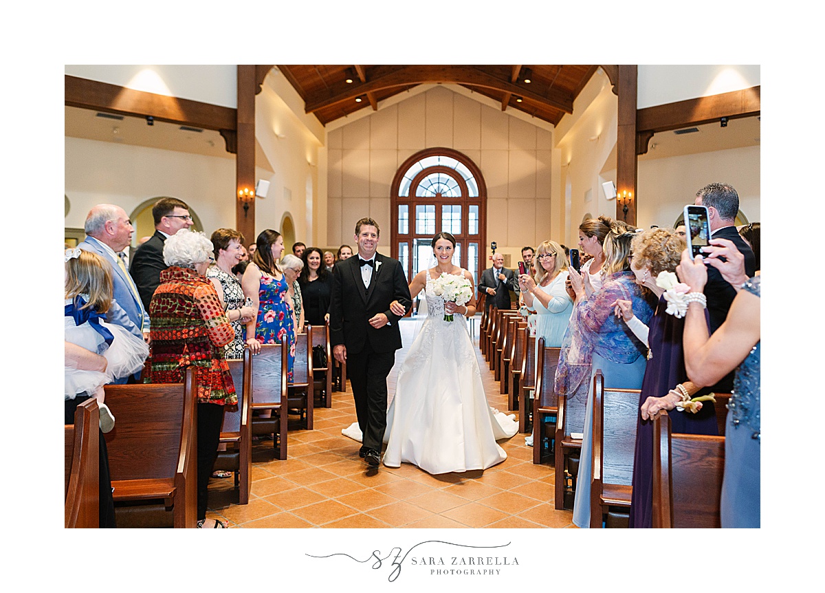 bride walks down aisle with dad at Providence College