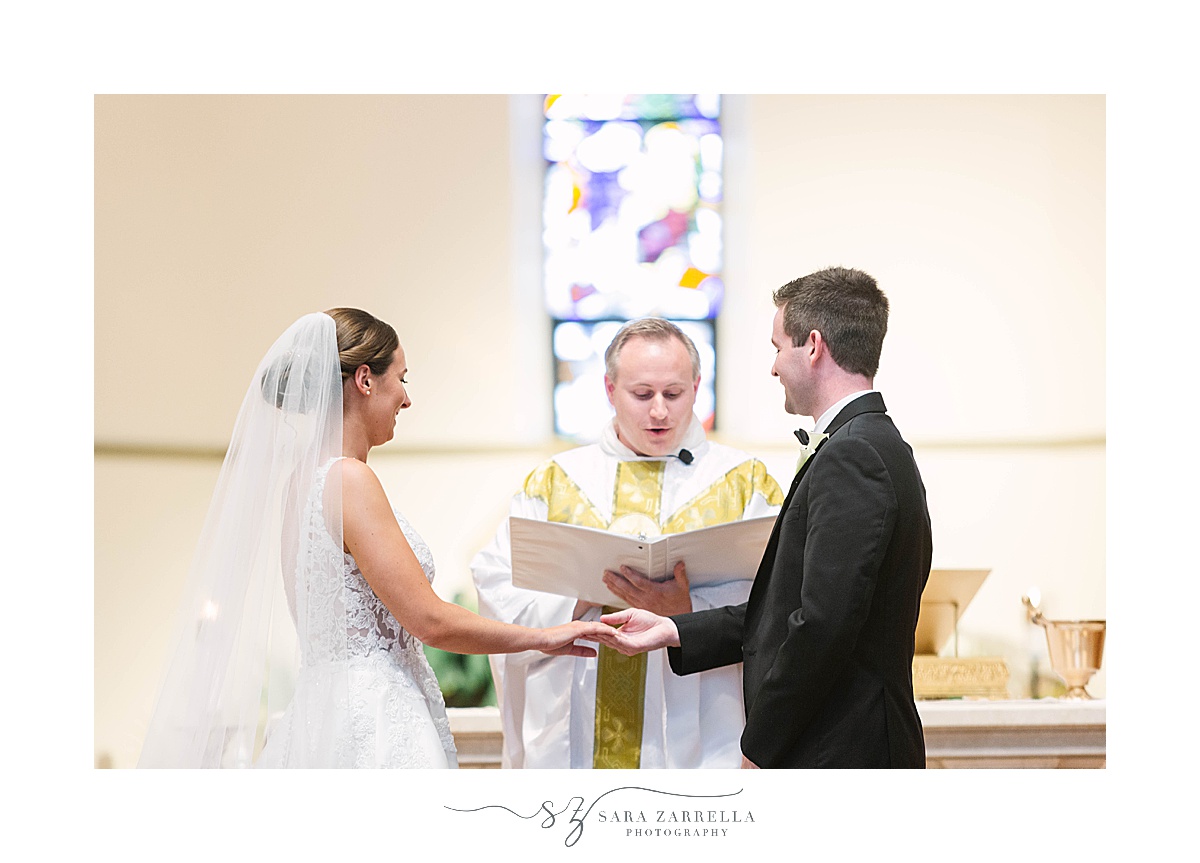 bride and groom exchange vows in Providence College chapel