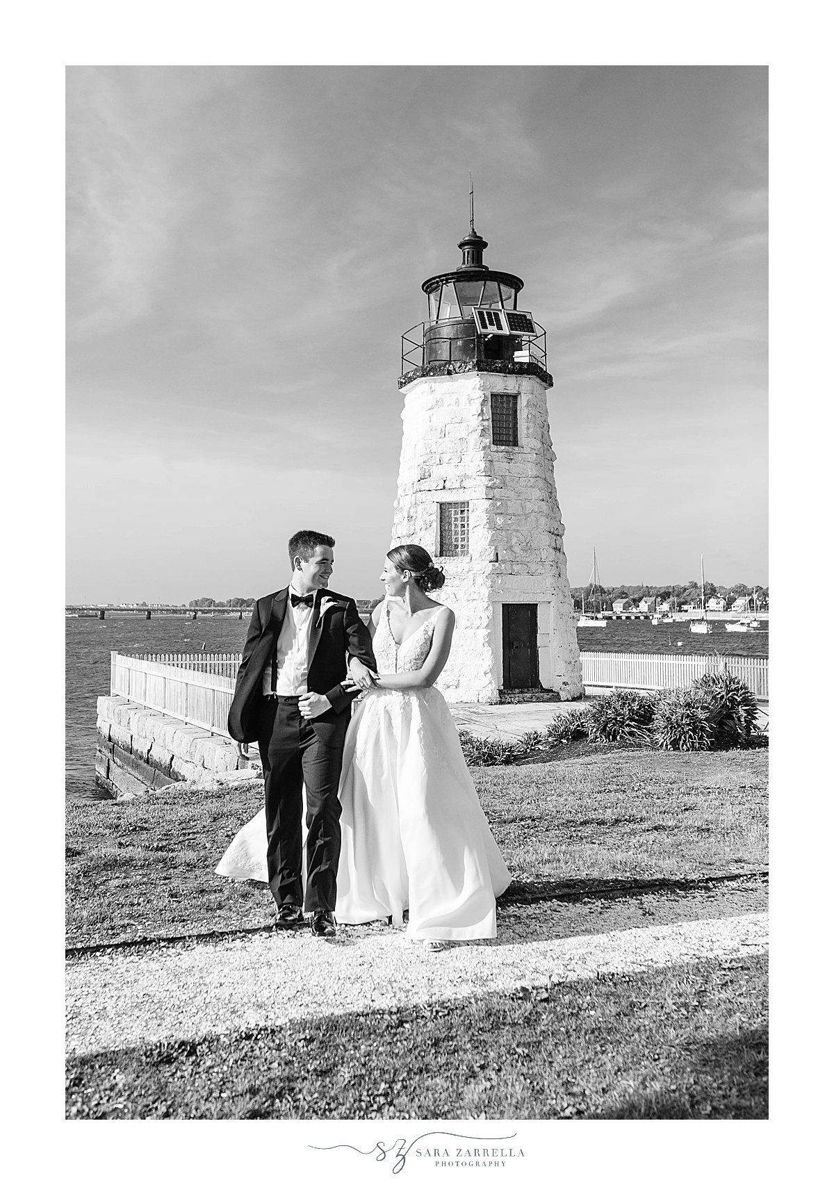 newlyweds pose by lighthouse in Newport RI