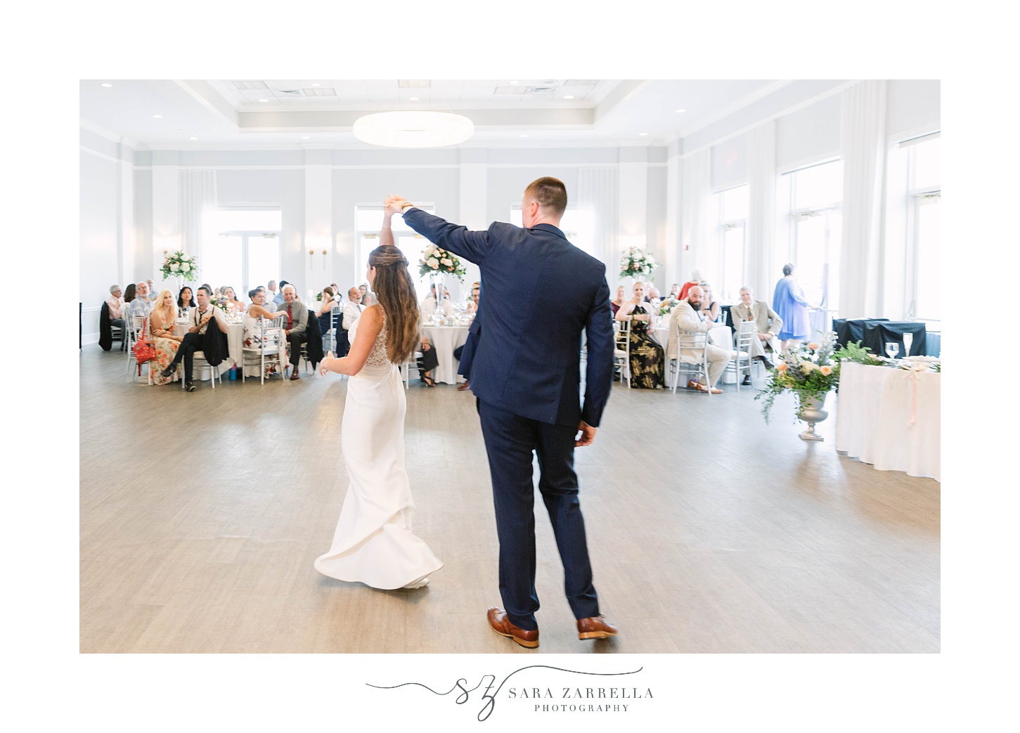 groom twirls bride during first dance at Newport RI wedding reception