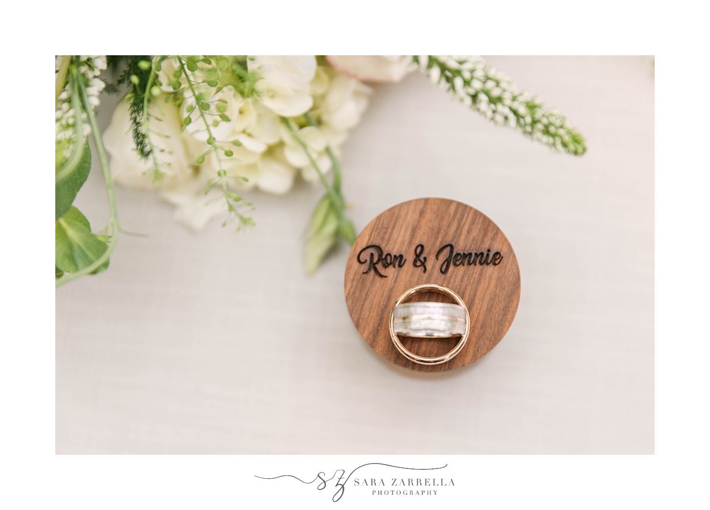 wedding rings rest on wooden box for MA wedding