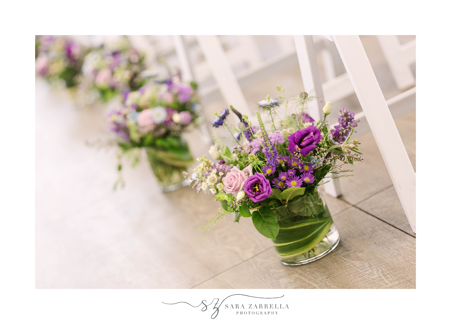 purple flowers next to chairs at Popponesset Inn wedding ceremony