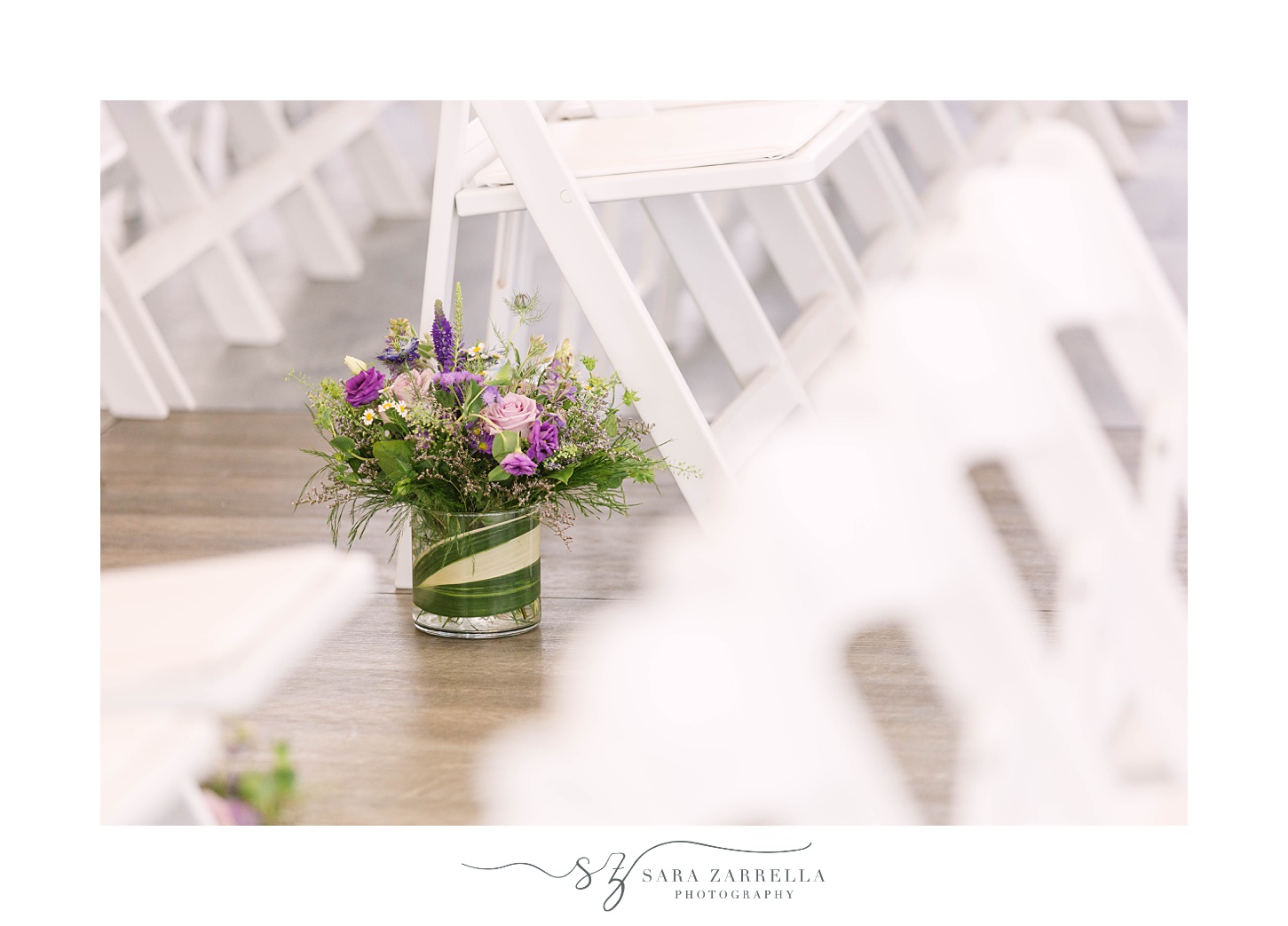 purple flowers under white chairs during Popponesset Inn wedding ceremony