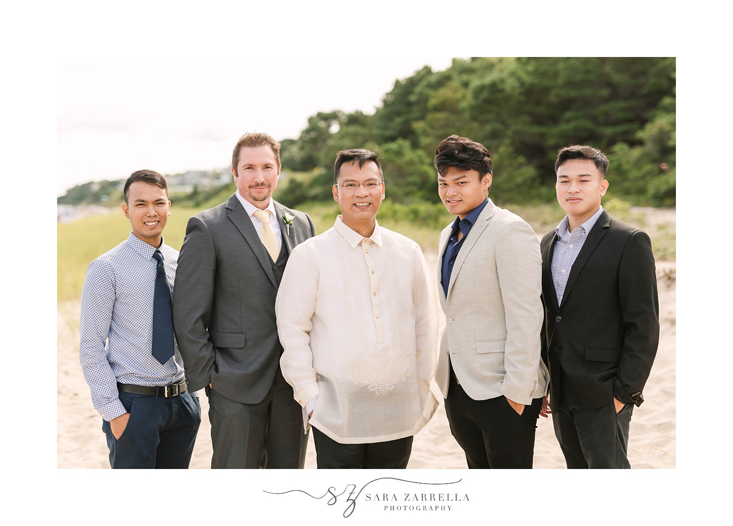 groom poses with brothers on beach before Popponesset Inn wedding 