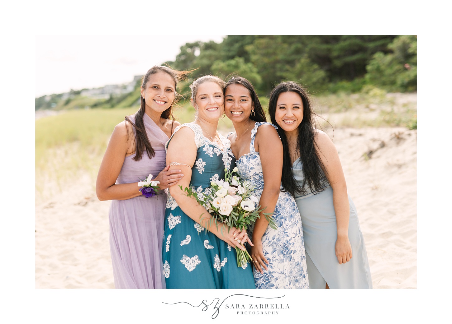 bride poses with friends on beach