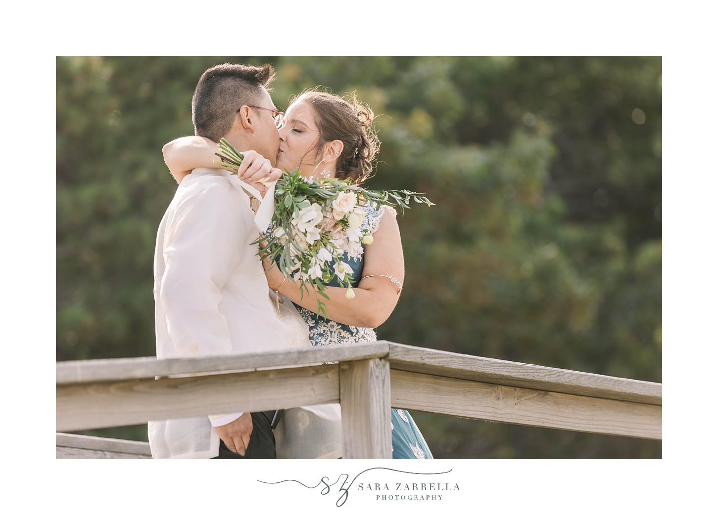 newlyweds kiss on beach in MA during wedding portraits 