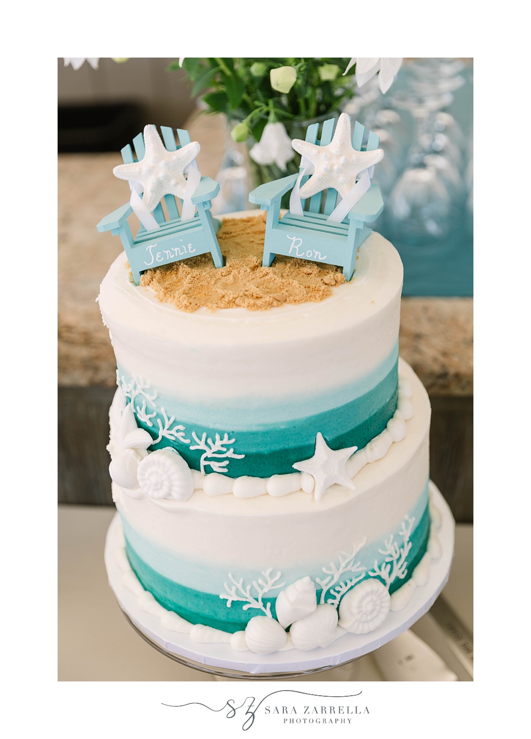 tiered wedding cake with beach inspired toppers