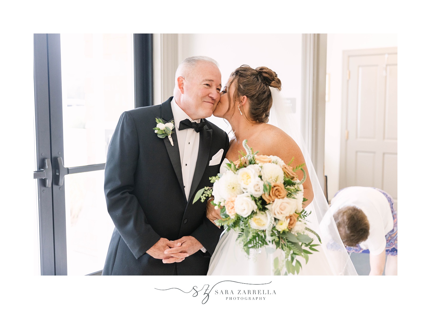 bride kisses dad's cheek before traditional church wedding in Massachusetts