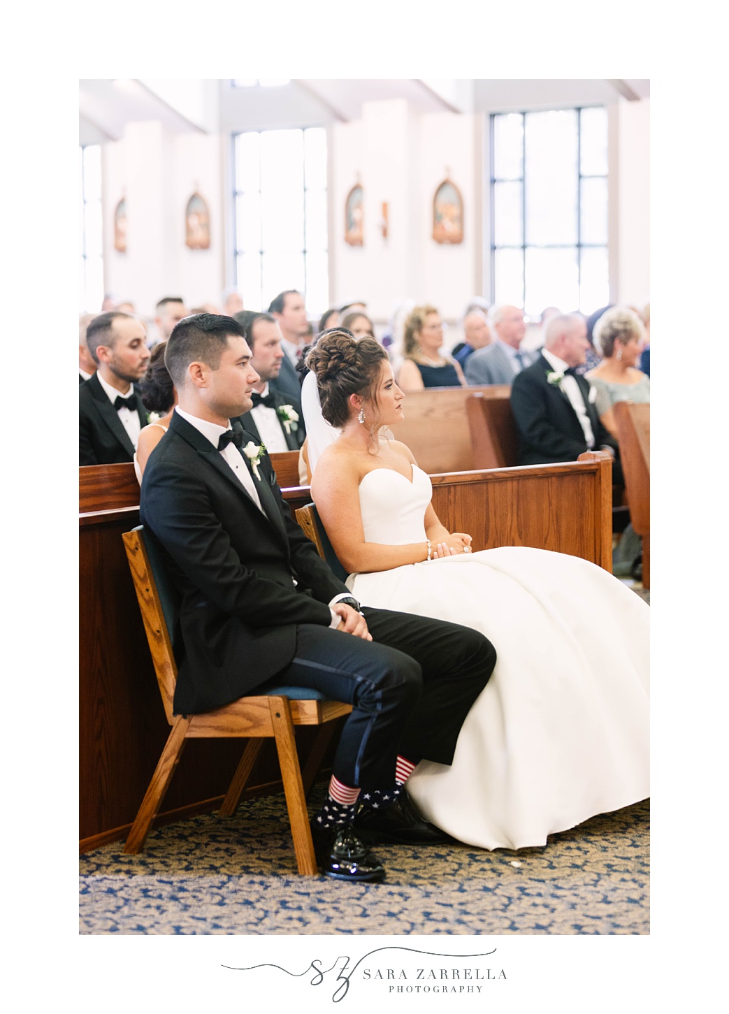 newlyweds sit together during traditional church wedding in Massachusetts