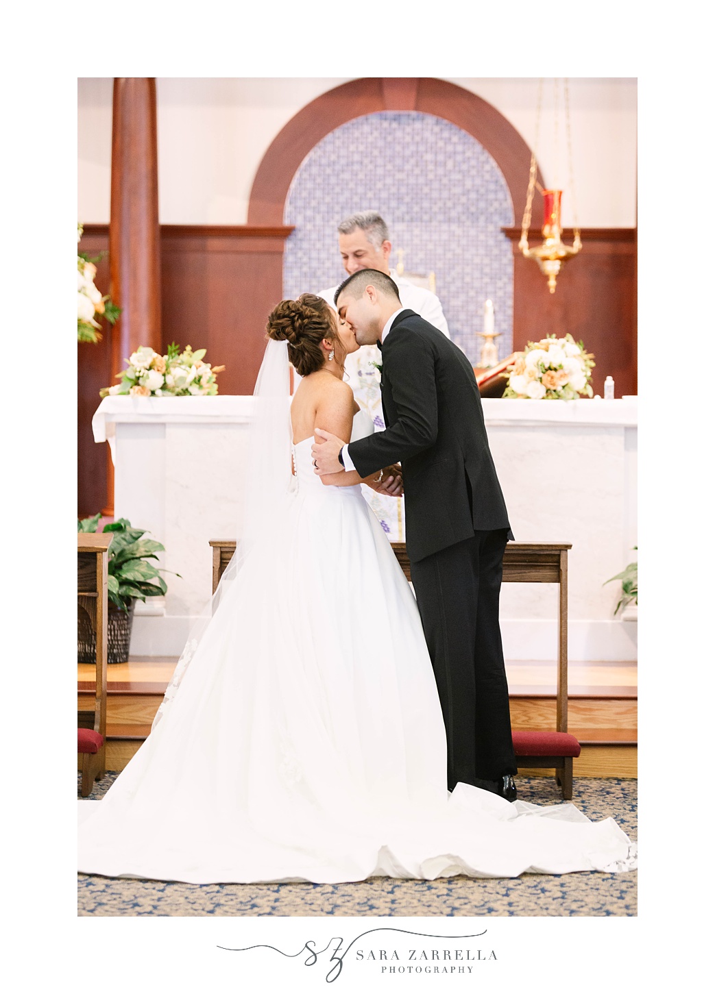 bride and groom kiss during traditional church wedding in Massachusetts