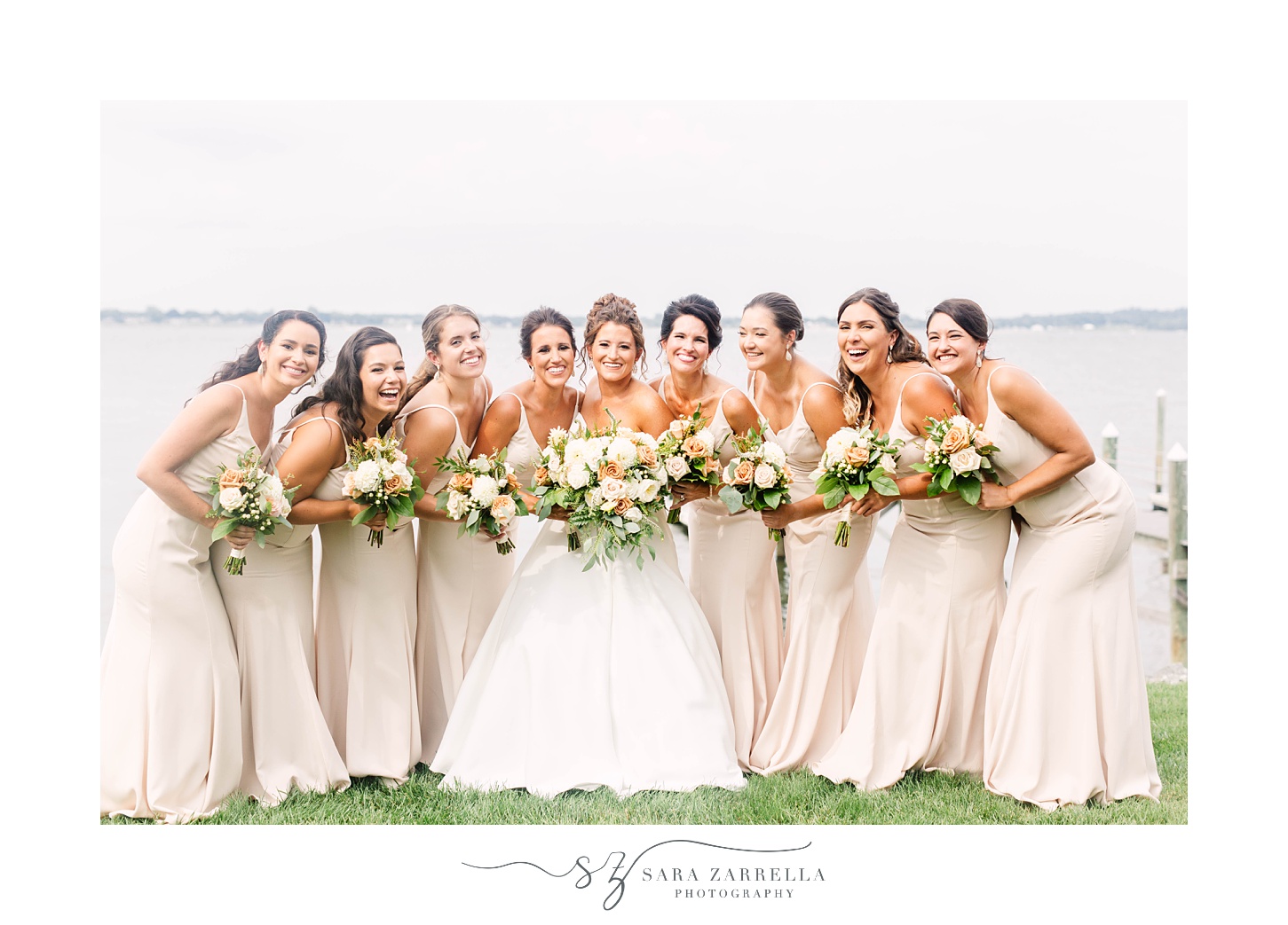 bride poses with bridesmaids in blush gowns at Lakeview Pavilion