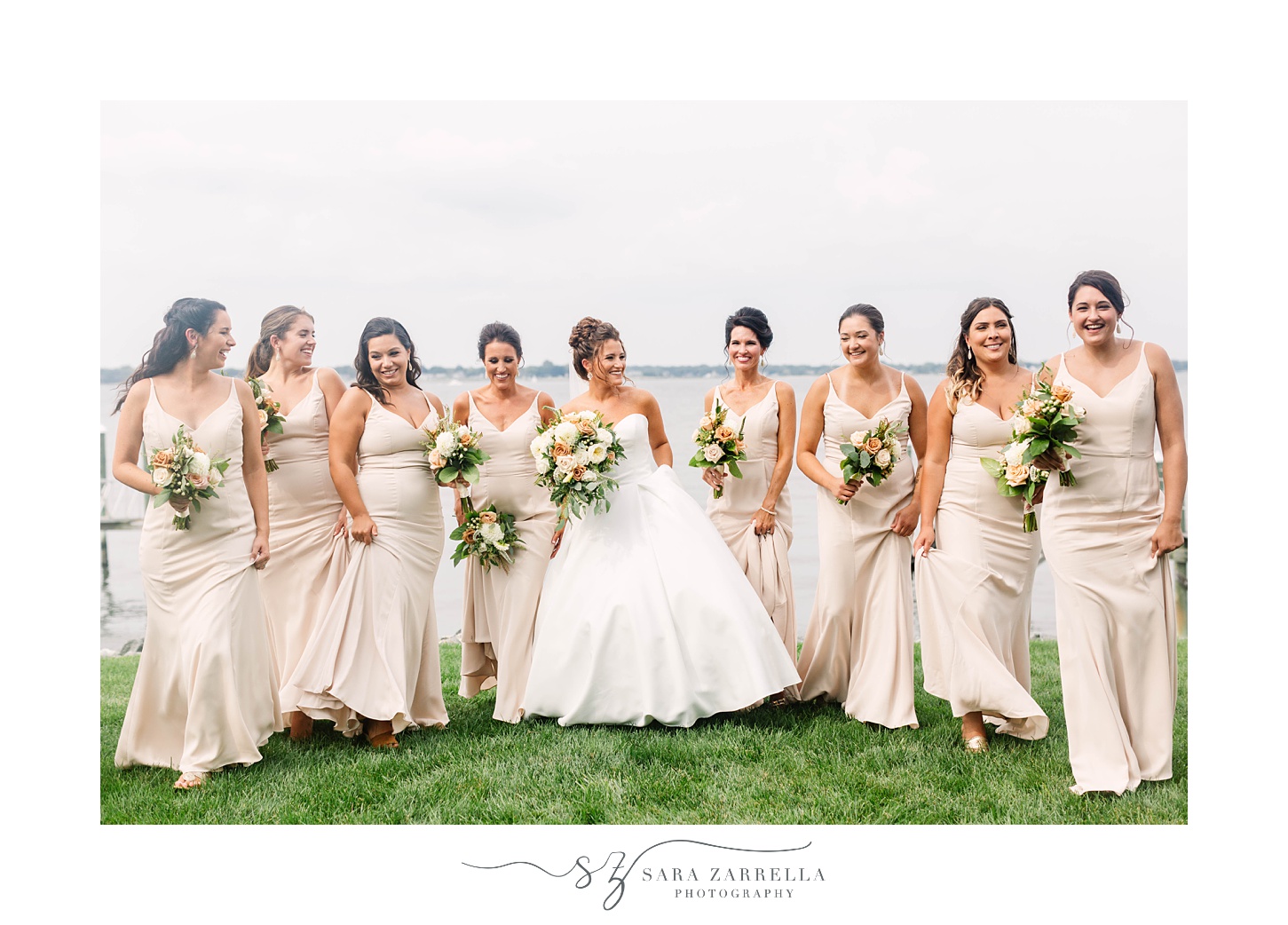 bride poses with bridesmaids in champagne gowns at Lakeview Pavilion