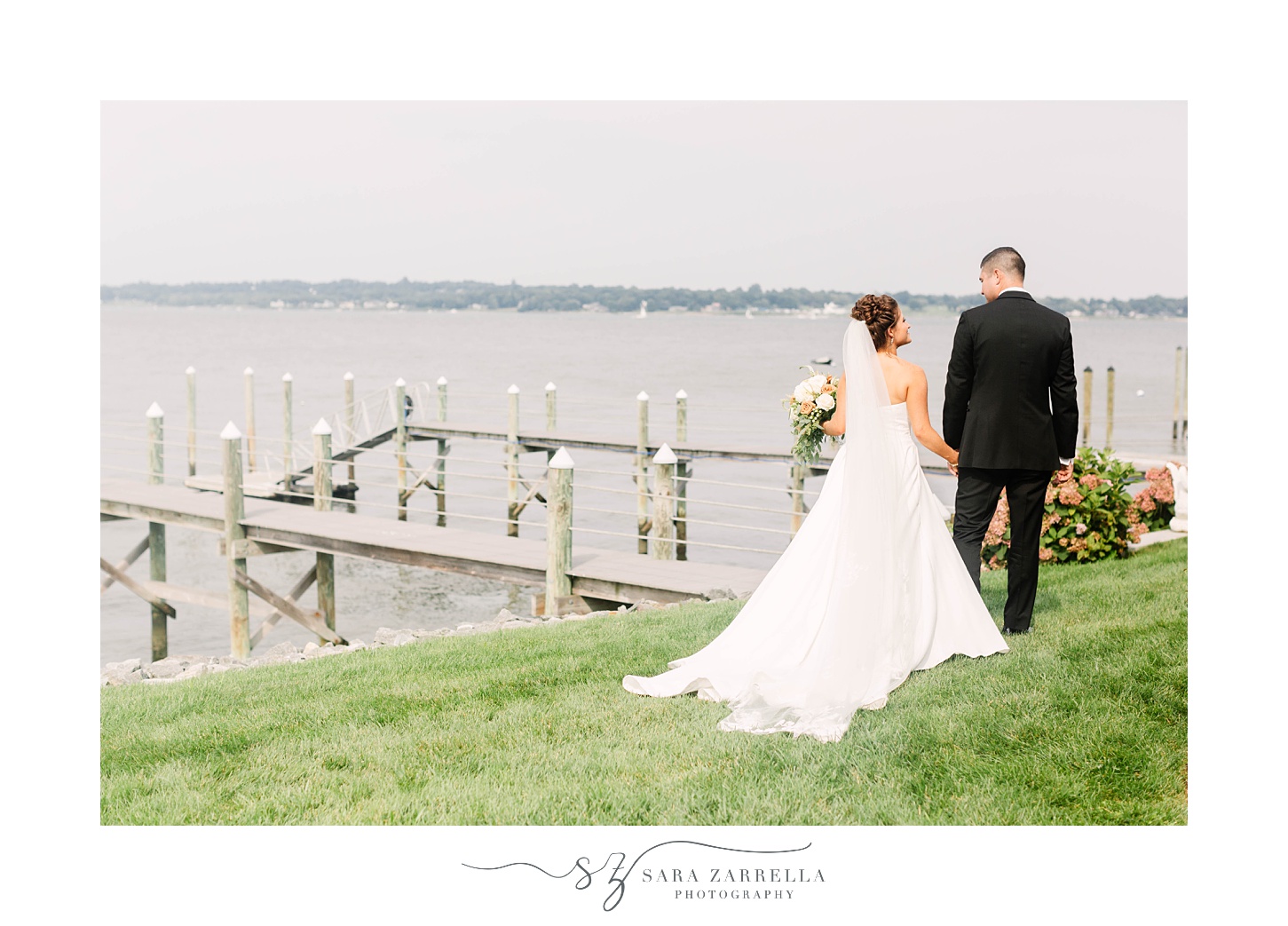 bride and groom walk outside dock at Lakeview Pavilion