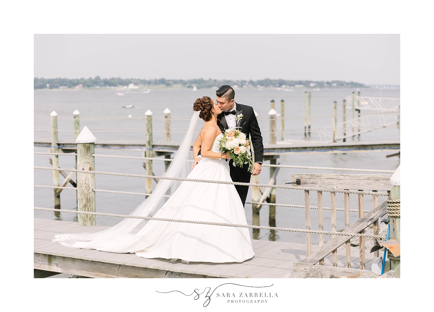 bride and groom kiss on dock outside Lakeview Pavilion