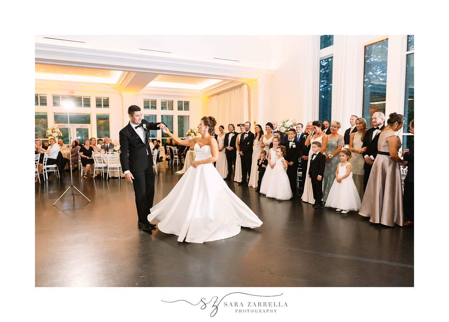 groom twirls bride on dance floor during Foxboro MA wedding reception