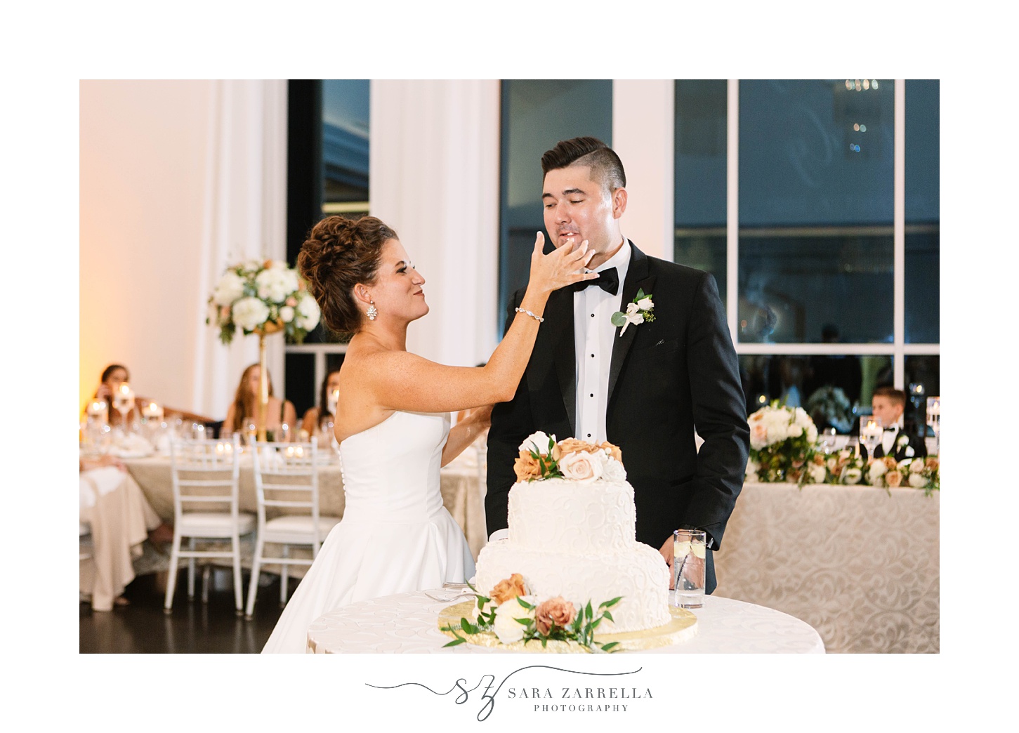 bride feeds groom cake during Foxboro MA wedding reception