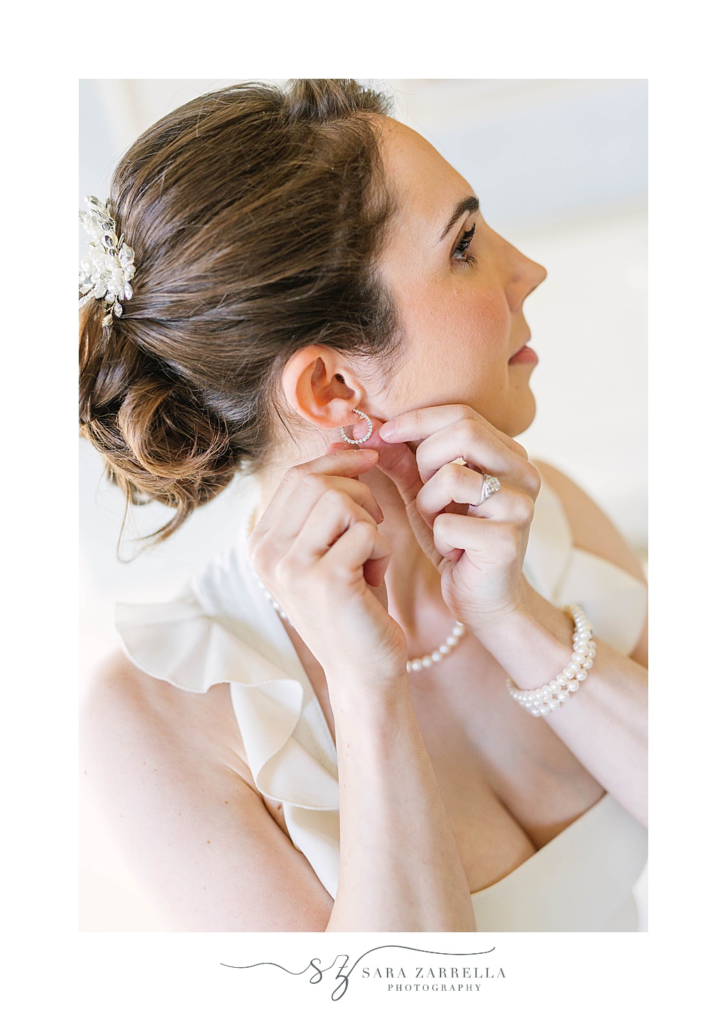 bride adjusts earring during Rhode Island wedding day