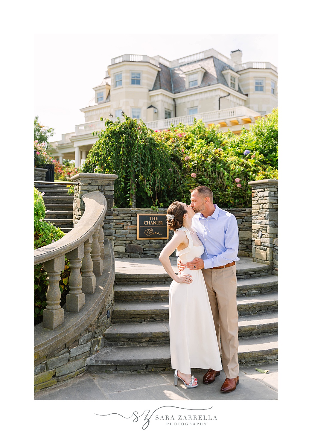 couple kisses by staircase at the Chanler at Cliff Walk