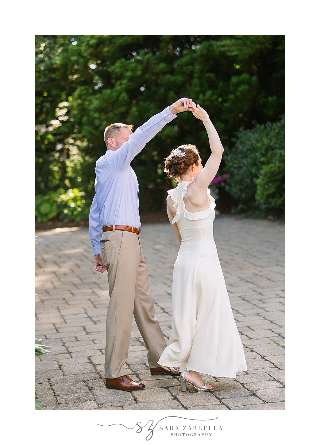 groom twirls wife during The Chanler at Cliff Walk Vow Renewal portraits 