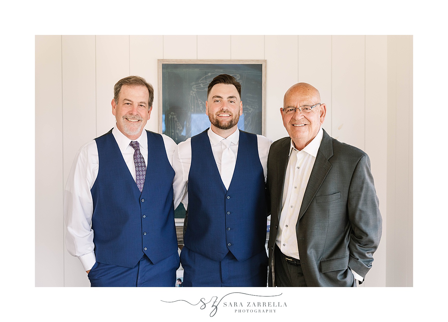 groom, dad, and grandfather hug on wedding morning 