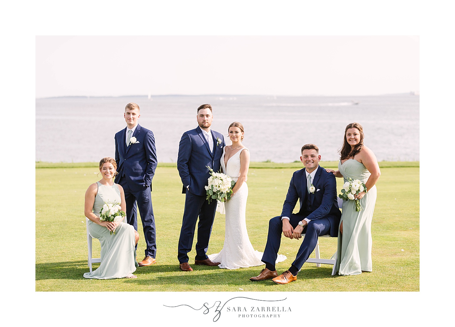 newlyweds pose with bridal party on green at Warwick Country Club