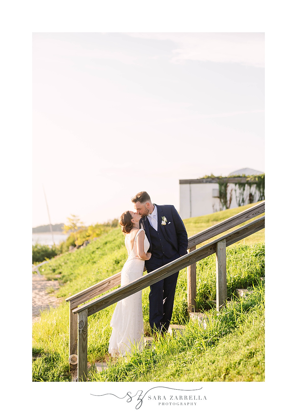 newlyweds kiss on wooden walkway at Warwick Country Club